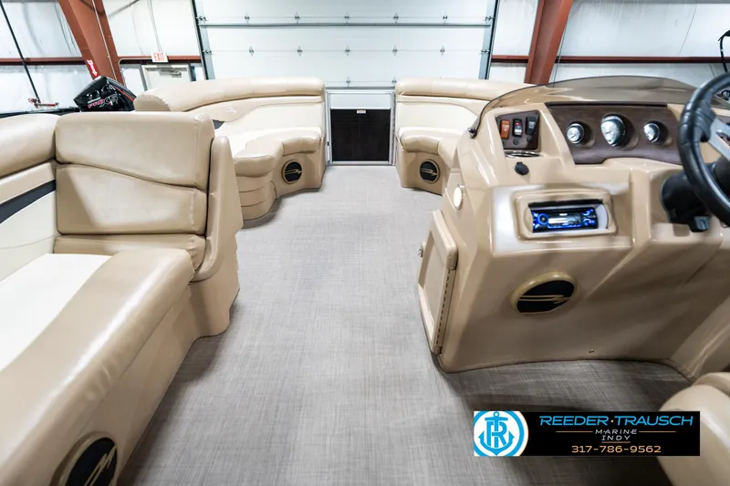 Slide: The Image of Interior of a 2016 Bennington 20 SLMX pontoon boat with beige seating. - 20