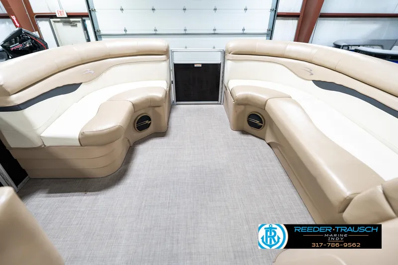 Slide: The Image of 2016 Bennington 20 SLMX pontoon boat interior with beige seating and carpeted floor. - 21