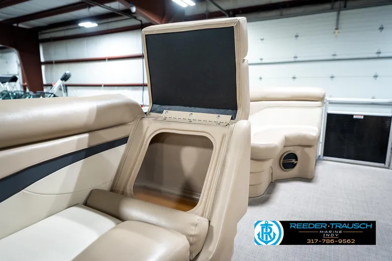 Slide: The Image of 2016 Bennington 20 SLMX boat interior with open storage compartment in a showroom. - 24