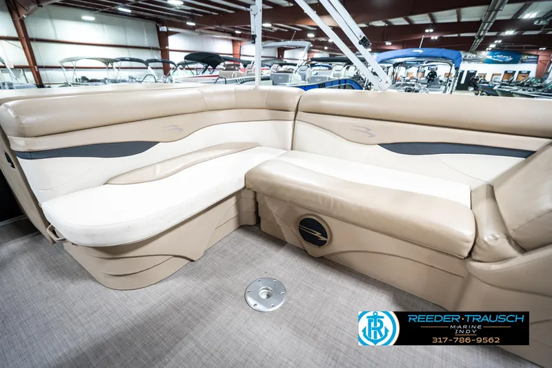 Slide: The Image of 2016 Bennington 20 SLMX pontoon boat interior with beige seating in showroom. - 26