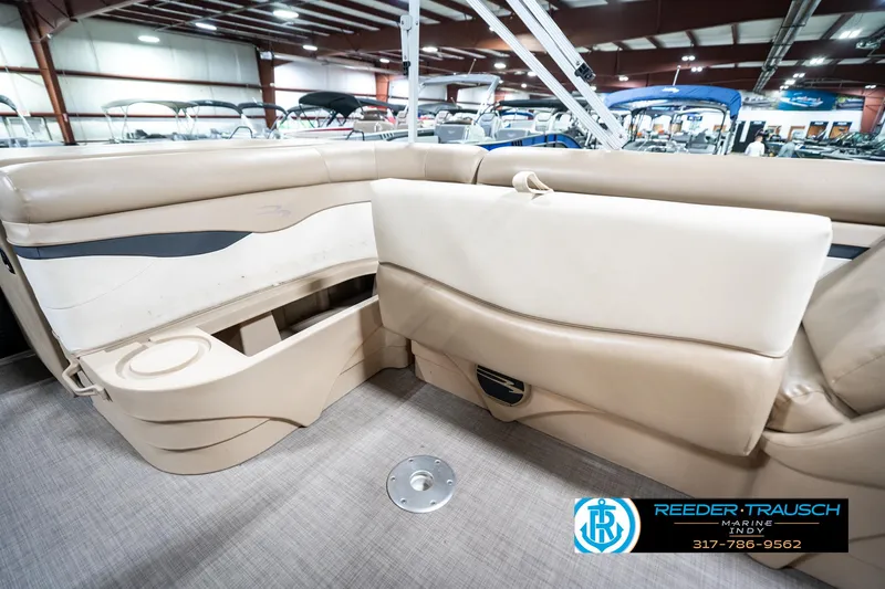 Slide: The Image of 2016 Bennington 20 SLMX boat interior with beige seating and cup holder. - 27