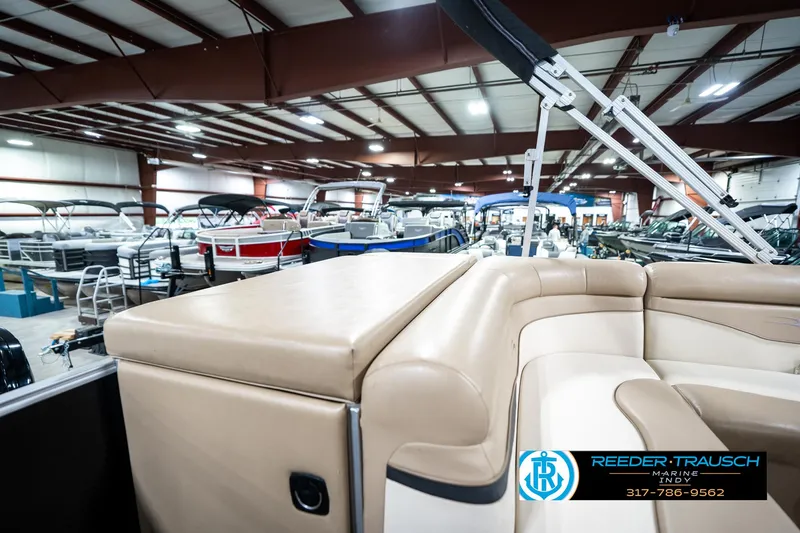 Slide: The Image of 2016 Bennington 20 SLMX pontoon boat in showroom with other boats. - 28