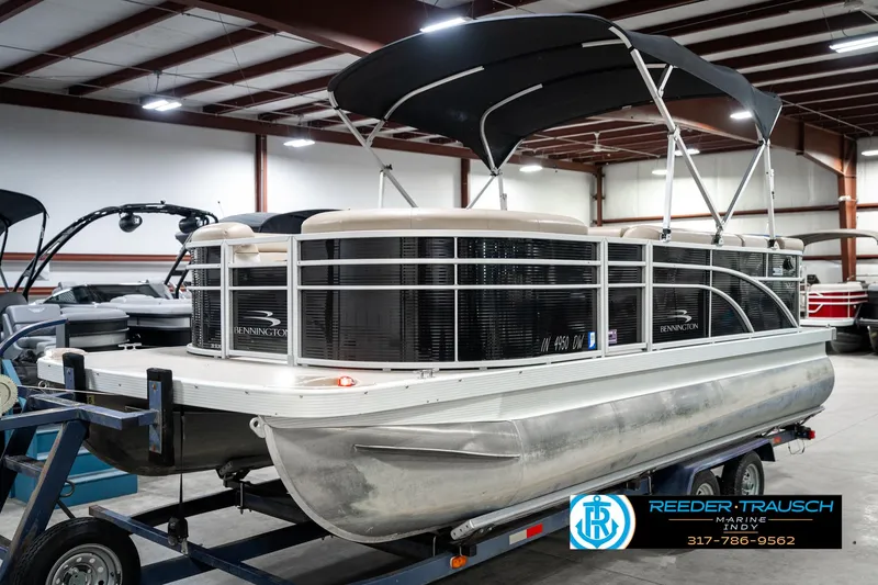 Slide: The Image of 2016 Bennington 20 SLMX pontoon boat with canopy on trailer in warehouse. - 3