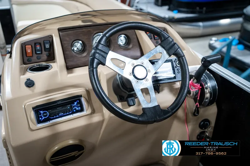 Slide: The Image of Steering console of a 2016 Bennington 20 SLMX boat with controls and dashboard. - 31