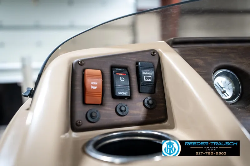 Slide: The Image of Dashboard controls of a 2016 Bennington 20 SLMX boat with cup holder. - 34