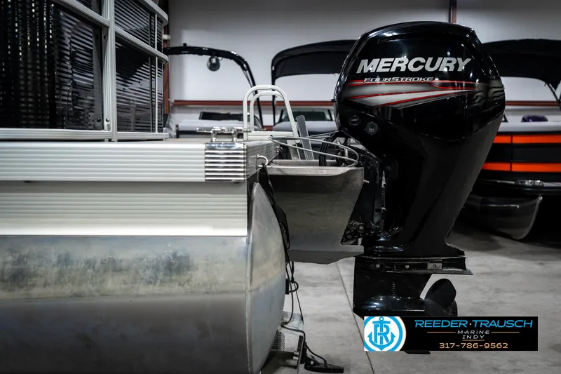Slide: The Image of 2016 Bennington 20 SLMX pontoon boat with Mercury outboard motor in a showroom. - 42