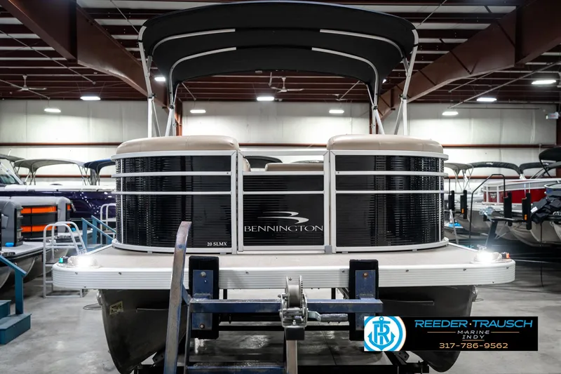 Slide: The Image of 2016 Bennington 20 SLMX pontoon boat in showroom, front view with canopy. - 5
