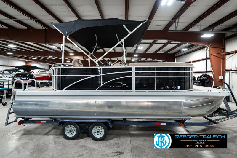 Slide: The Image of 2016 Bennington 20 SLMX pontoon boat on trailer in indoor showroom. - 7