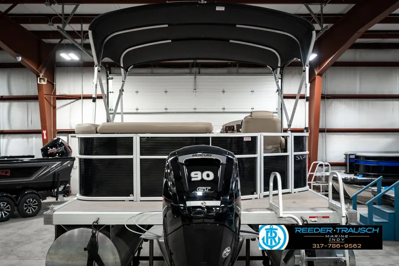 Slide: The Image of 2016 Bennington 20 SLMX pontoon boat with 90 HP engine in indoor showroom. - 9
