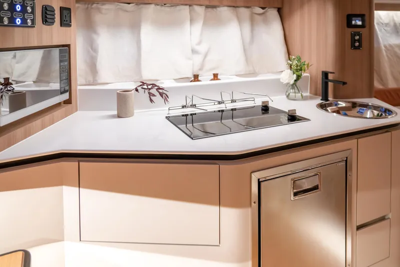 Slide: The Image of Modern kitchen interior in 2025 Oryx 37 FX RV with sleek appliances and minimalist design. - 11