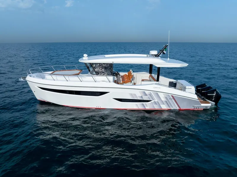 Slide: The Image of 2025 Oryx 37 FX yacht cruising on open sea under clear blue sky. - 5