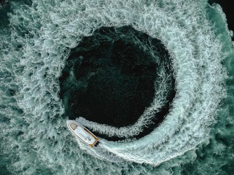 Slide: The Image of Aerial view of Oryx 37 FX boat creating circular waves, 2025 model. - 6
