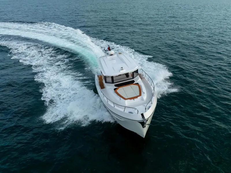 Slide: The Image of 2025 Oryx 37 FX yacht cruising on open water, aerial view. - 9