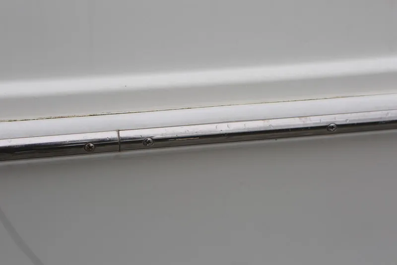 Slide: The Image of Close-up of a metal railing on a 2012 Carver 38 Super Sport boat. - 10