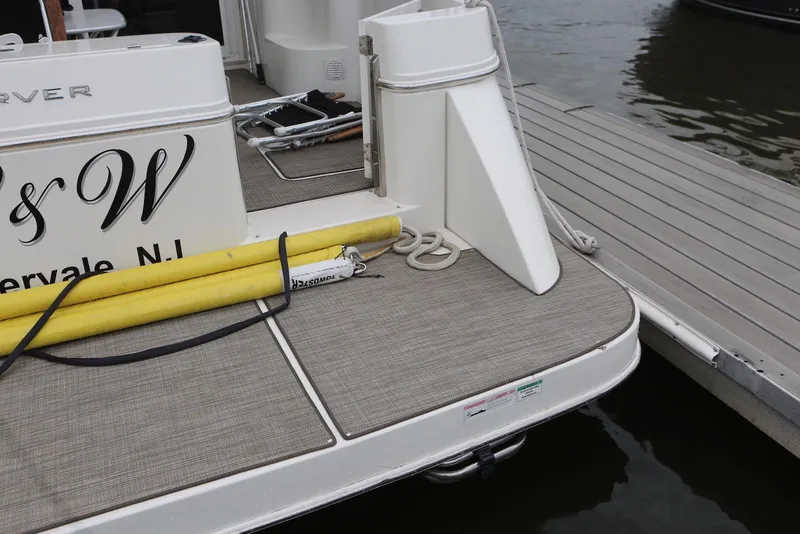 Slide: The Image of Carver 38 Super Sport 2012 yacht docked, featuring deck details and mooring equipment. - 14