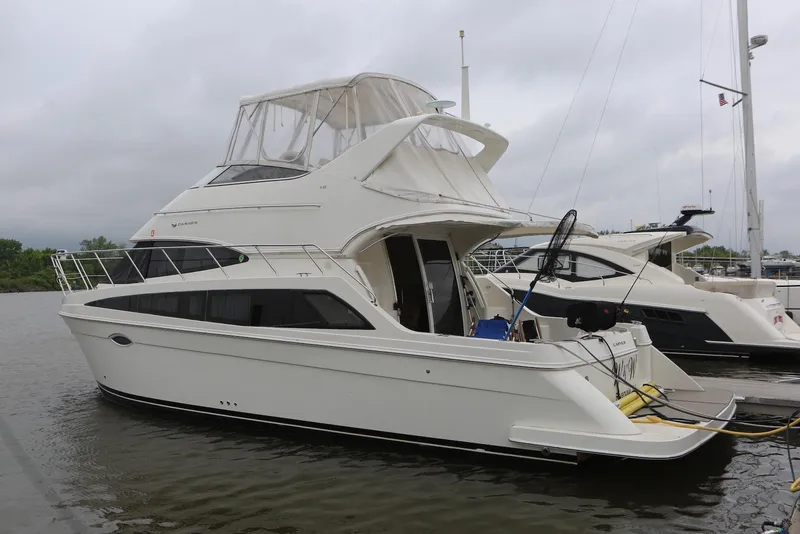 Slide: The Image of 2012 Carver 38 Super Sport yacht docked on a cloudy day. - 2