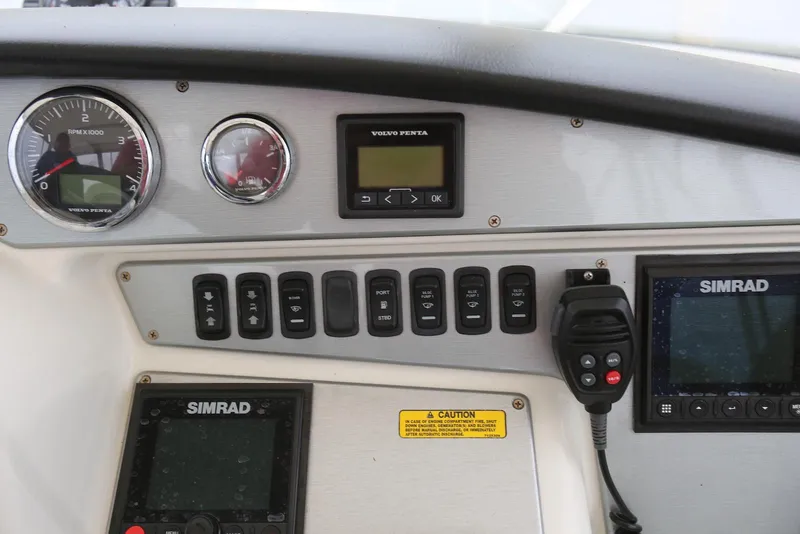 Slide: The Image of Control panel of 2012 Carver 38 Super Sport with Simrad displays and Volvo Penta gauge. - 29