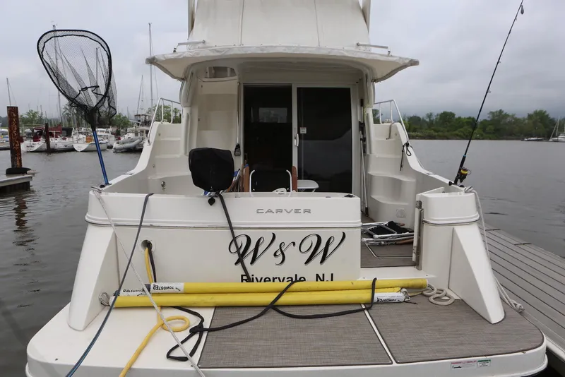 Slide: The Image of 2012 Carver 38 Super Sport yacht docked, rear view with fishing gear, Rivervale, NJ. - 3