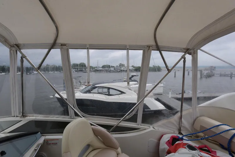 Slide: The Image of 2012 Carver 38 Super Sport yacht docked at a marina, viewed from inside another boat. - 32