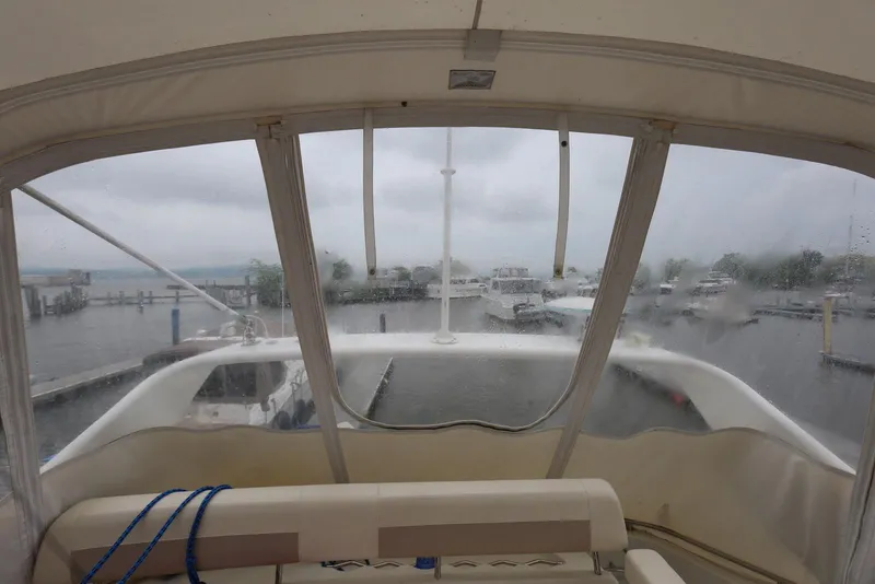 Slide: The Image of Interior view from a 2012 Carver 38 Super Sport yacht, overlooking a marina on a rainy day. - 38