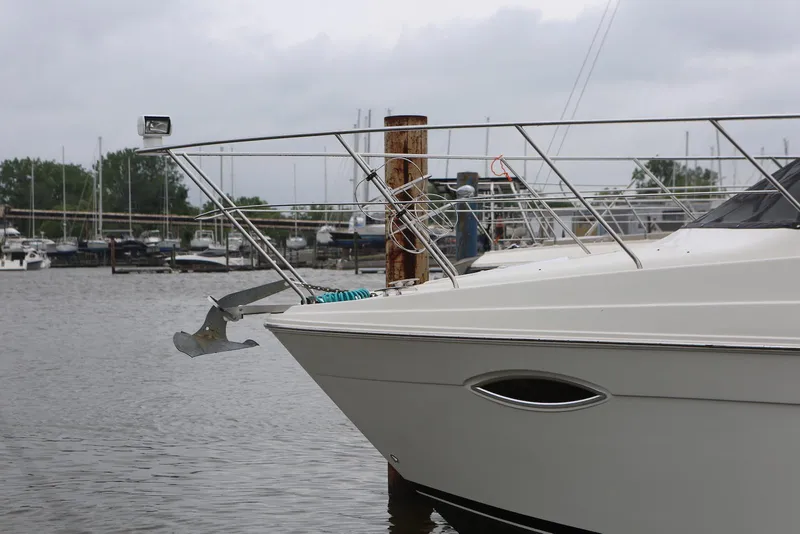 Slide: The Image of 2012 Carver 38 Super Sport yacht docked in a marina, overcast sky. - 4