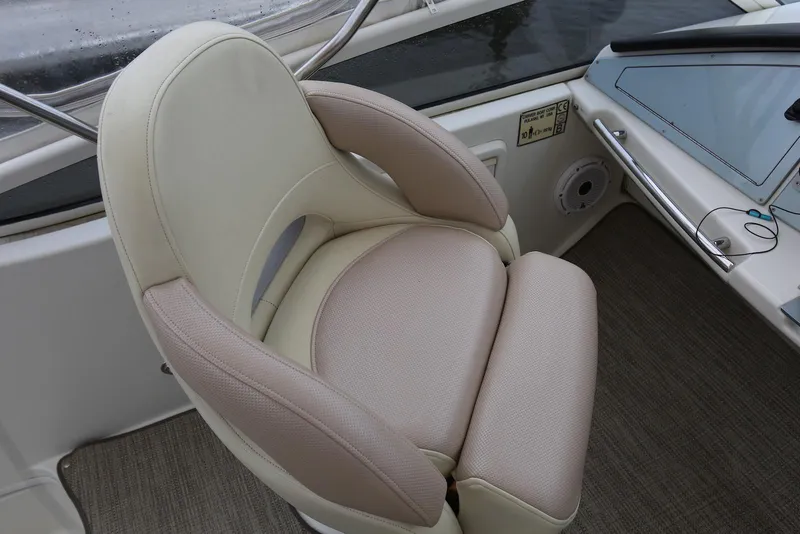 Slide: The Image of Captain's chair on 2012 Carver 38 Super Sport boat, featuring beige and tan upholstery. - 45