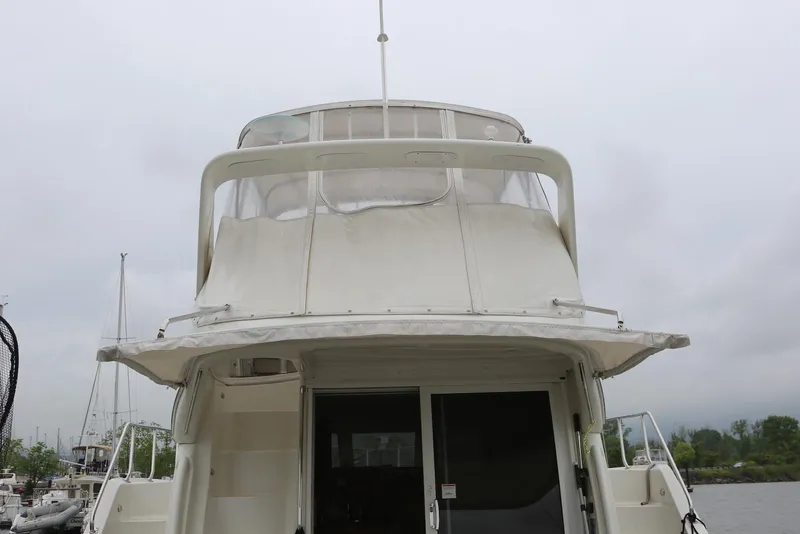 Slide: The Image of 2012 Carver 38 Super Sport yacht, rear view, docked on a cloudy day. - 5