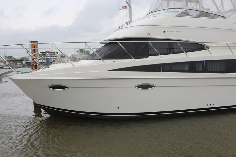 Slide: The Image of 2012 Carver 38 Super Sport yacht docked in calm waters. - 7