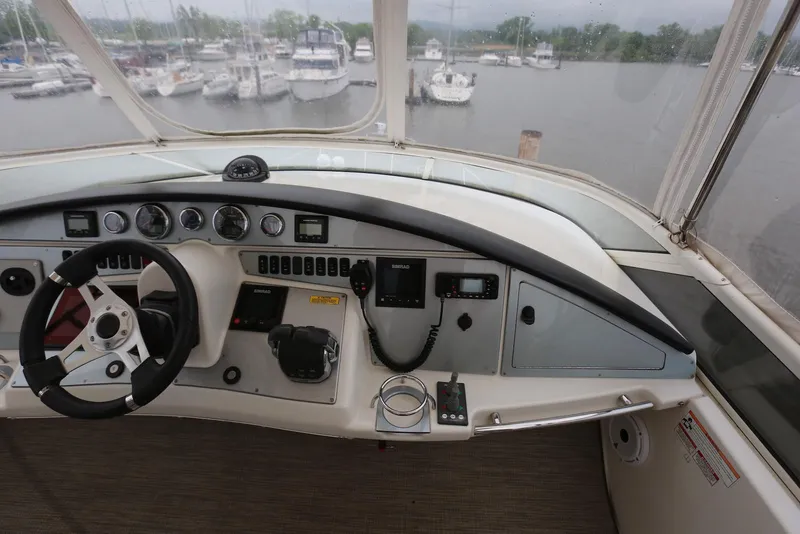 Slide: The Image of Cockpit of 2012 Carver 38 Super Sport yacht with steering wheel and control panel. - 11