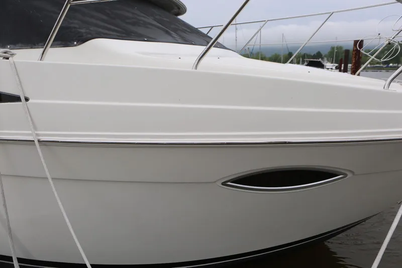 Slide: The Image of 2012 Carver 38 Super Sport boat docked, showcasing sleek white exterior design. - 12