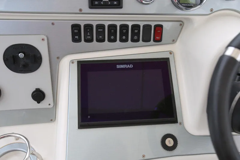 Slide: The Image of Control panel of 2012 Carver 38 Super Sport with Simrad display and switches. - 21
