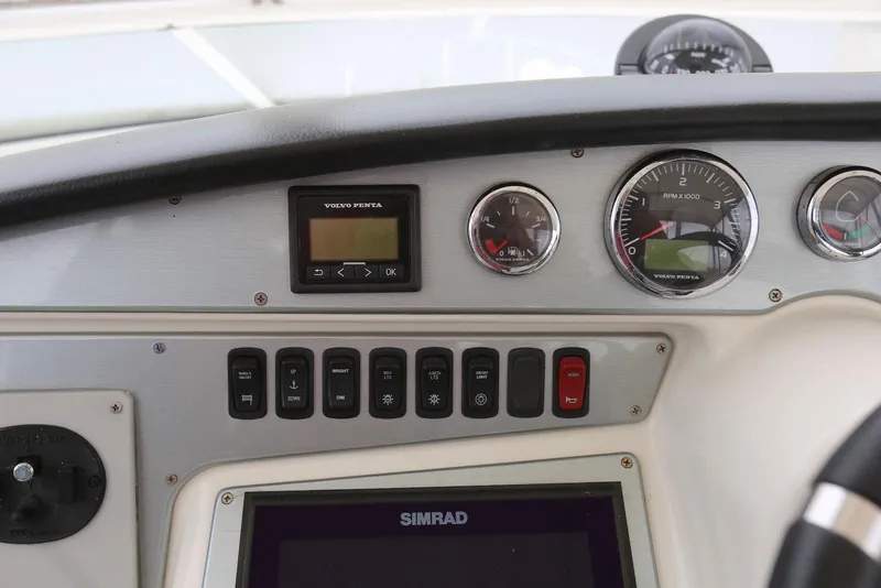 Slide: The Image of Control panel of a 2012 Carver 38 Super Sport boat with gauges and switches. - 24