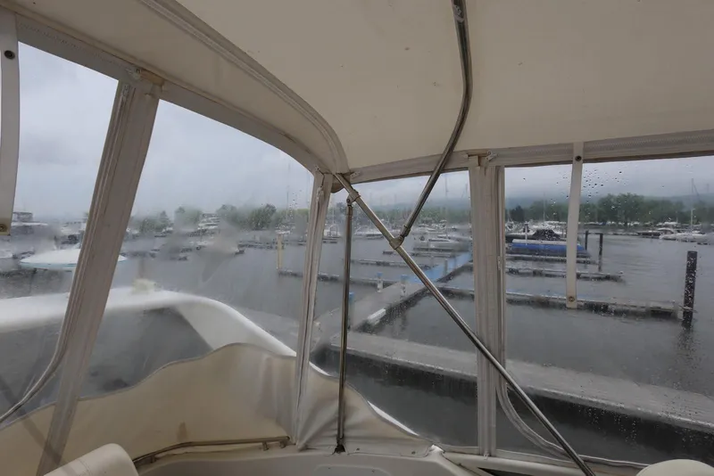 Slide: The Image of Interior view from a 2012 Carver 38 Super Sport yacht, overlooking a rainy marina. - 35