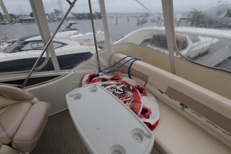 Slide: The Image of Interior of 2012 Carver 38 Super Sport yacht with seating and table, docked at marina. - 36