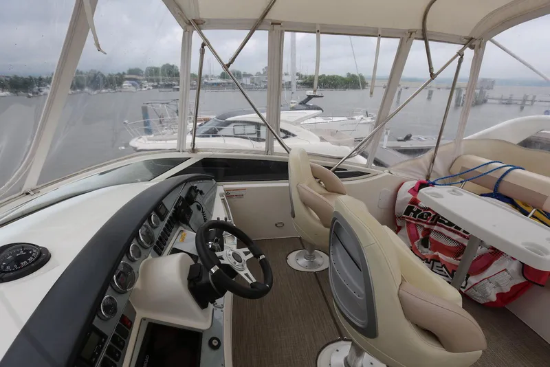 Slide: The Image of Interior view of 2012 Carver 38 Super Sport yacht cockpit with marina backdrop. - 39