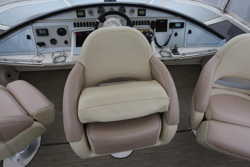 Slide: The Image of Captain's chairs and dashboard of 2012 Carver 38 Super Sport boat. - 42
