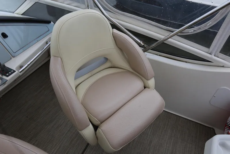 Slide: The Image of Captain's chair on 2012 Carver 38 Super Sport boat, featuring beige upholstery and ergonomic design. - 47
