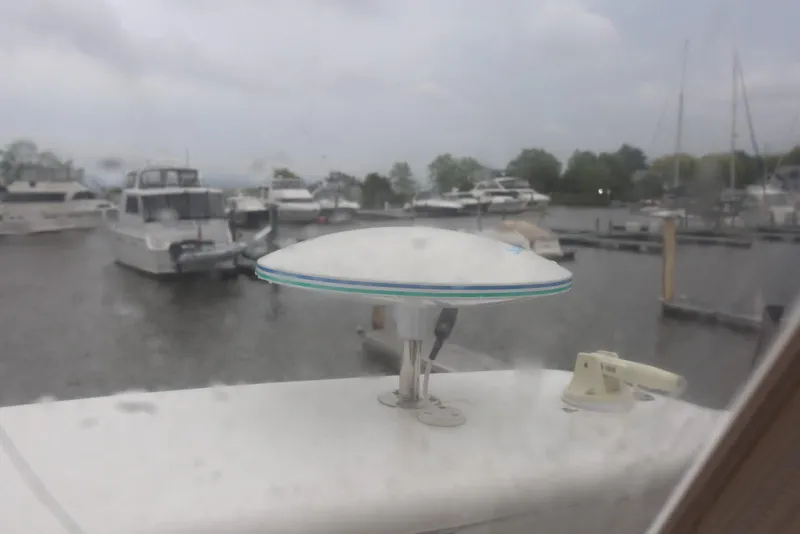 Slide: The Image of Carver 38 Super Sport 2012 at marina, rainy day, boats in background. - 49