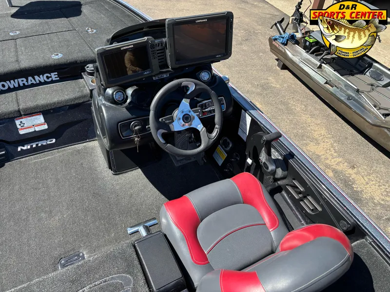 Slide: The Image of 2015 Nitro Z-9 boat cockpit with steering wheel, dual screens, and red-gray seating. - 5