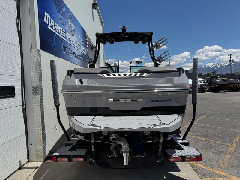 Slide: The Image of 2020 Supra SE550 boat rear view at a marina, showcasing sleek design and equipment. - 4