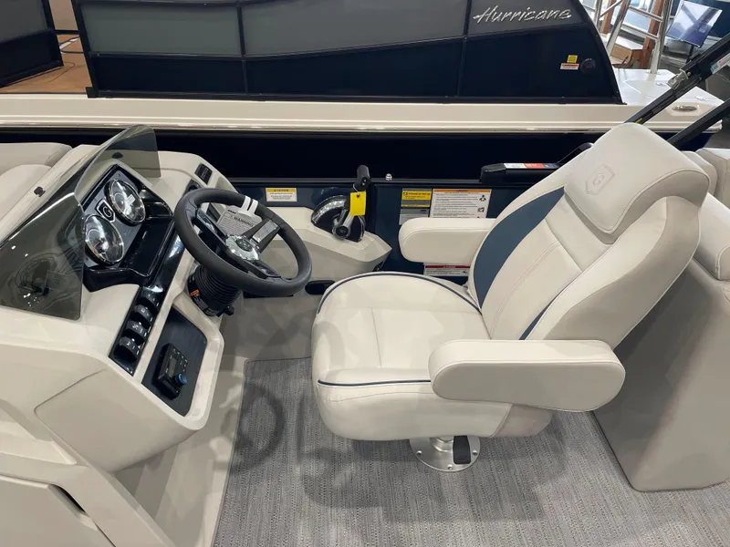 Slide: The Image of 2025 Godfrey SWEETWATER 2286 SB boat interior with steering wheel and captain's chair. - 10
