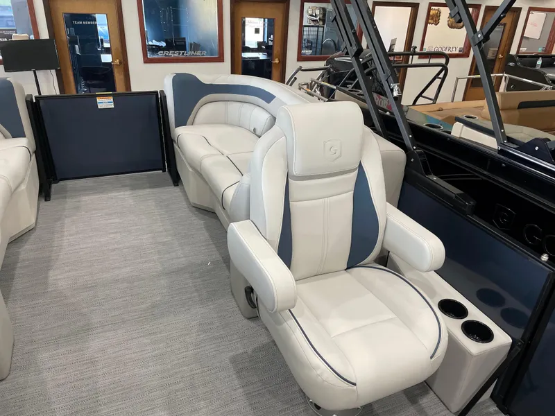 Slide: The Image of 2025 Godfrey SWEETWATER 2286 SB boat interior with luxurious seating and cup holders. - 9