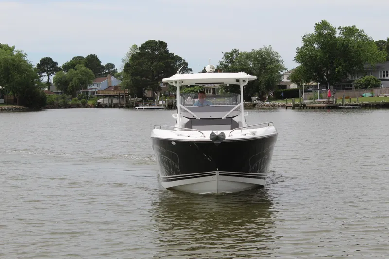 Slide: The Image of 2023 Jeanneau Leader 9.0 CC on a boat stand. - 3