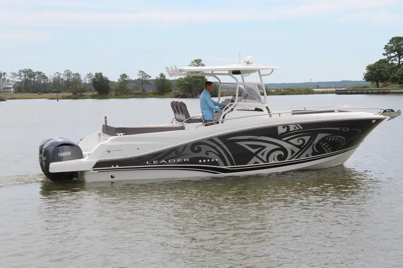 Slide: The Image of 2023 Jeanneau Leader 9.0 CC on calm water in harbor. - 8