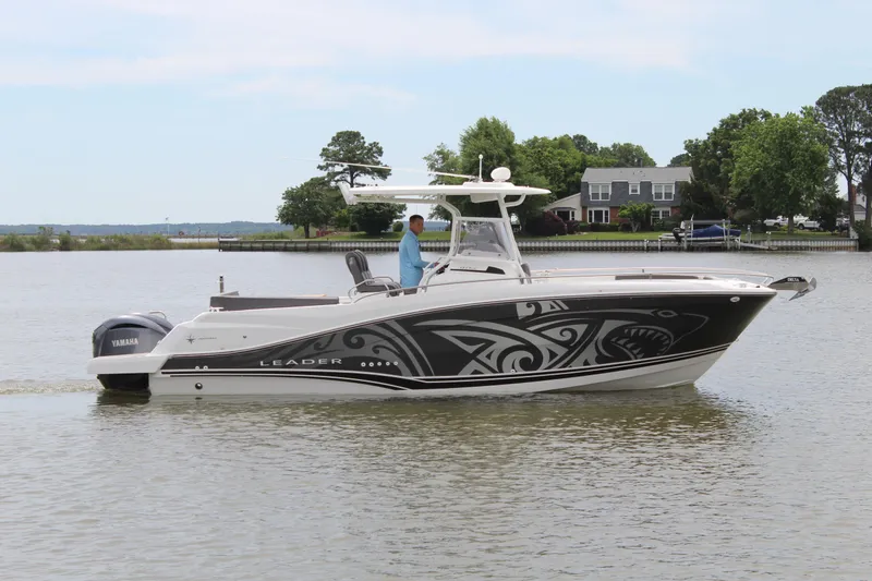 Slide: The Image of Jeanneau Leader 9.0 CC 2023 on calm water near dock. - 9