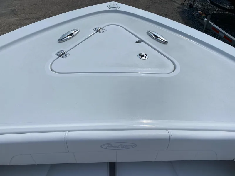 Slide: The Image of 2025 Pair Customs 21 Center Console DV boat deck with storage hatch and sleek design. - 12
