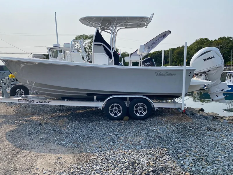 Slide: The Image of 2025 Pair Customs 21 Center Console DV boat on trailer at marina. - 2