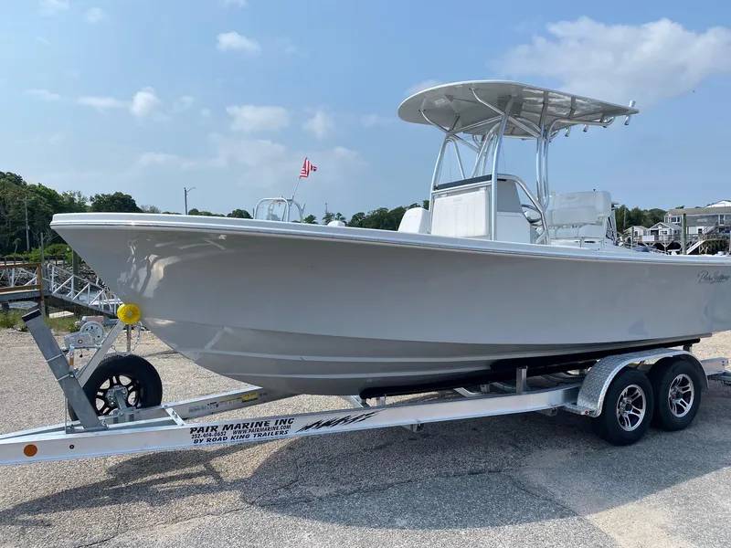 Slide: The Image of 2025 Pair Customs 21 Center Console DV boat on trailer, sunny day, American flag in background. - 4