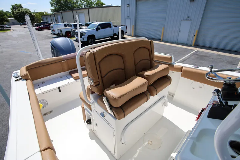 Slide: The Image of 2019 Sea Hunt Ultra 255 SE boat interior with tan seating and steering wheel. - 10