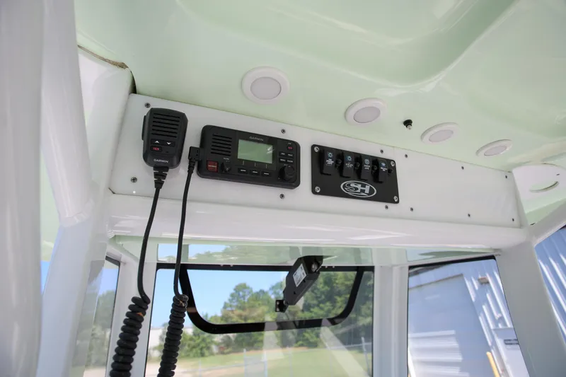 Slide: The Image of 2019 Sea Hunt Ultra 255 SE boat console with Garmin radio and control panel. - 14